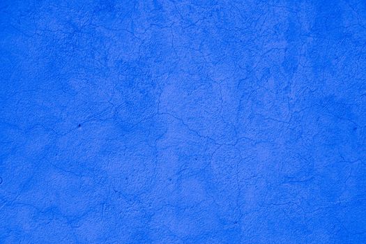 Surface of blue embossed plaster on wall.