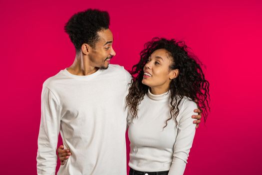 Portrait of young african american match on red studio background. Love, holidays, happiness concept