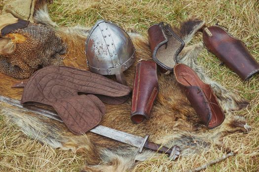 Old Viking armor on yellowed grass. Viking Festival in Denmark