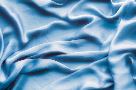 Blue soft silk waves, flatlay - elegant fabric textures, abstract backgrounds and modern pastel colours concept. Feel the touch of luxury