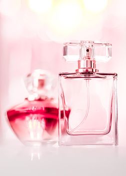 Perfume bottles on glamour background, floral feminine scent, fragrance and eau de parfum as luxury holiday gift, cosmetic and beauty brand present concept