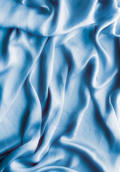 Blue soft silk waves, flatlay - elegant fabric textures, abstract backgrounds and modern pastel colours concept. Feel the touch of luxury