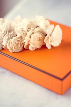 Present box and flowers for her - Mother's day ideas, happy giving and holiday inspiration concept. The perfect gift for mom