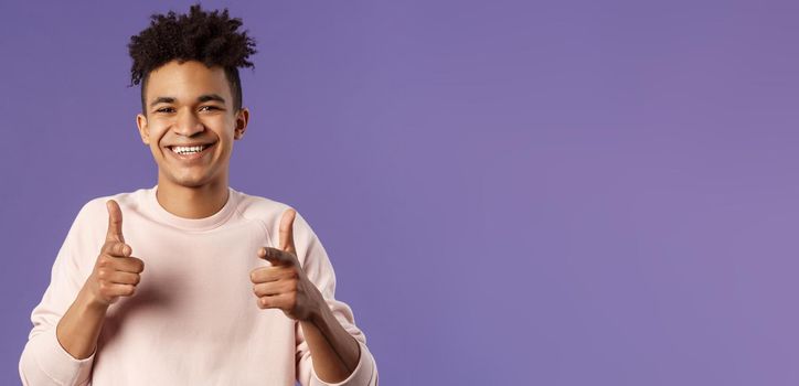 You got it. Close-up portrait of smiling cute young hispanic man saying good luck, pointing fingers at camera with pleased cute grin, encourage person apply for job, headhunter picking new candidates.