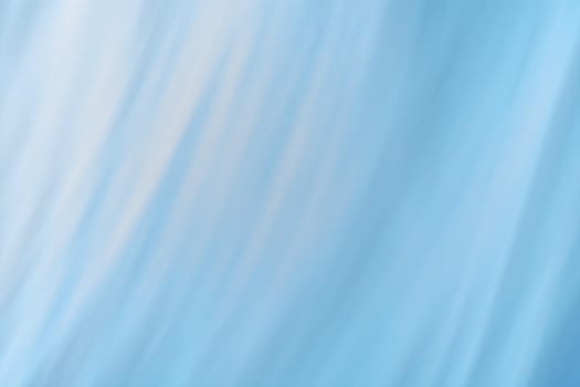 Gray-blue background of diagonal wavy lines and gradient. Abstraction. Backdrop