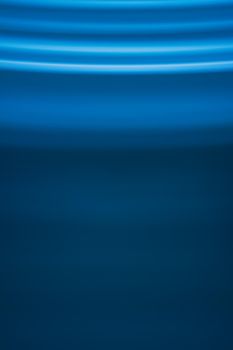 Abstract vertical background in blue tones with waves on top of the picture. Backdrop