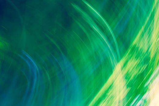 Bright abstract background in shades of green with a gradient and glowing stripes. Backdrop