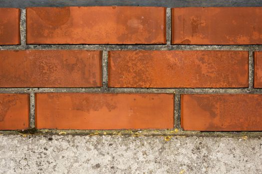 Brickwork of red brick for jointing on a concrete base.