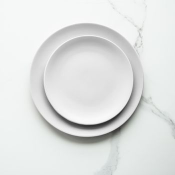 White empty plate on marble, flatlay - stylish tableware, romantic table decor and food menu concept. Serve the perfect dish