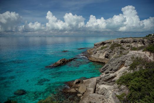 Rocky Caribbean Sea coastline with rocks and azure water on the Isle of Women