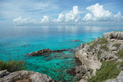 Rocky Caribbean Sea coastline with rocks and azure water on the Isle of Women