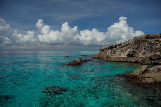 Rocky Caribbean Sea coastline with rocks and azure water on the Isle of Women