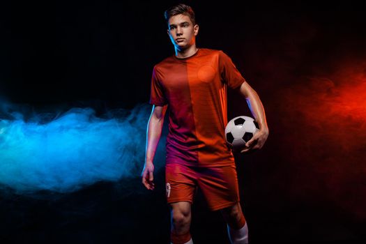 Kids in soccer sportswear on stadium with ball.