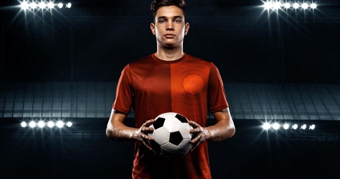 Kids in soccer sportswear on stadium with ball.