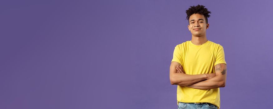 Close-up portrait of arrogant, proud and boastful young smart guy cross hands over chest in confident, self-assured pose, smirk and look mighty, feel like he knows everything, purple background.