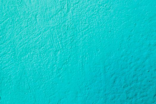 Surface of old worn blue green paint on wall.