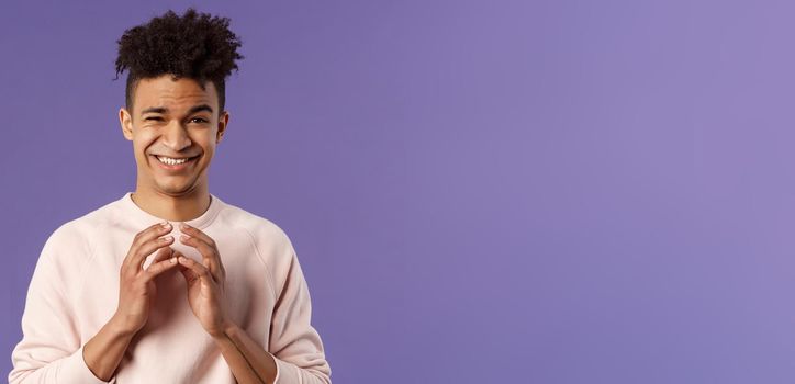 Portrait of creative young smart man with dreads, steeple fingers near chest and smirk devious, have perfect plan, scheming something for april fools day, standing purple background sly.