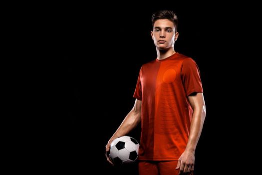 Kids in soccer sportswear on stadium with ball.