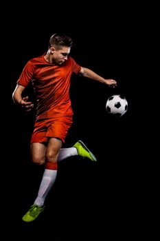 Kids in soccer sportswear on stadium with ball.