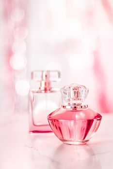 Perfume bottles on glamour background, floral feminine scent, fragrance and eau de parfum as luxury holiday gift, cosmetic and beauty brand present concept