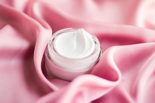 Beauty, anti-age cosmetics and skincare concept - Luxury face cream jar on a soft pink silk