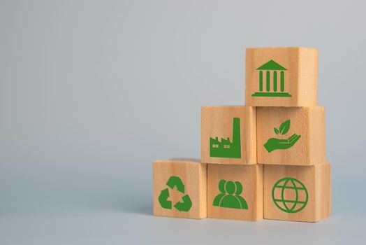 Wood cube block Esg Environmental Social and Governance eco concept of sustainable development of the organization.Investing and management of pollution to reduce global warming.