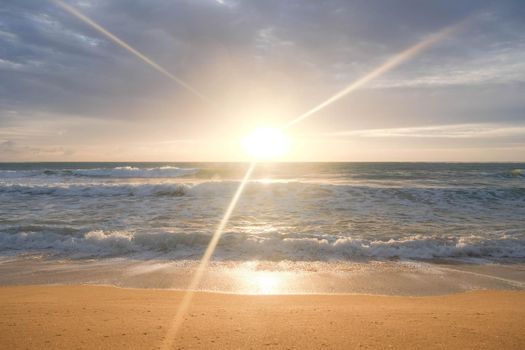 Beautiful sea waves and white sand beach in the tropical island. Beautiful view of the sunsets over sea. Ocean beach sunrise and dramatic colorful sky clouds