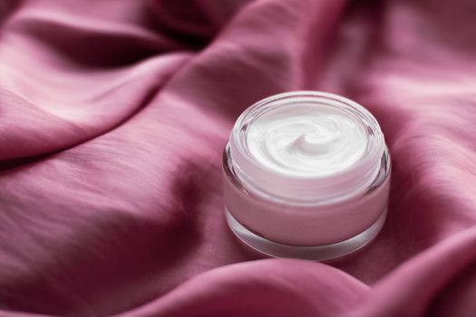 Beauty, anti-age cosmetics and skincare concept - Luxury face cream jar on a soft pink silk