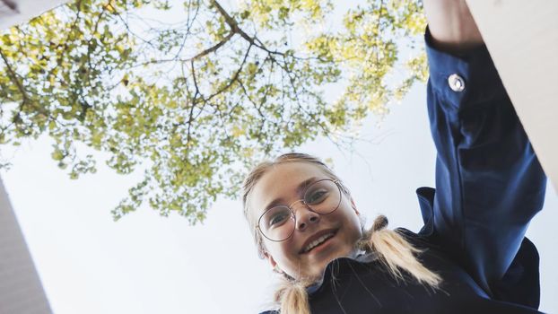 A girl opens a box in the park in admiration