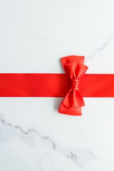 Holiday decor, feminine design and flatlay concept - Red silk ribbon on marble, top view