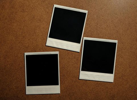 Three blank photo frames on brown table. download photo