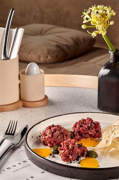 Chips bread with tartare vs carpaccio of beef on table at the restaurant. modern cuisine. Photo for the menu