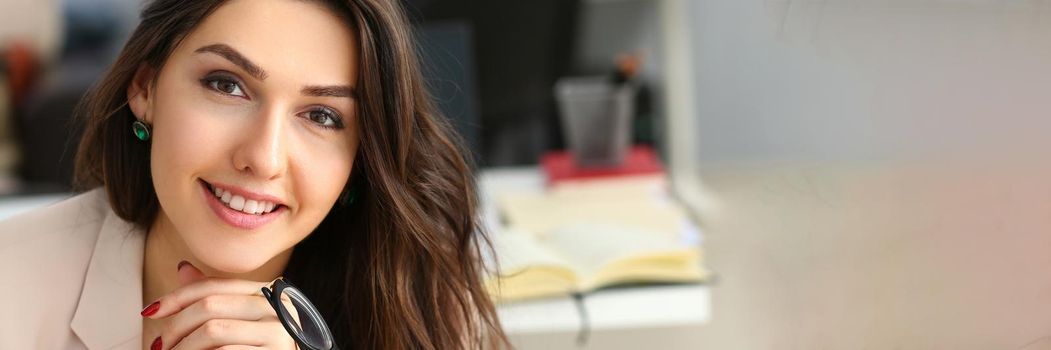 Smiling confident businesswoman at workplace looks up. Workplace worker dress code and job offer customer visit concept