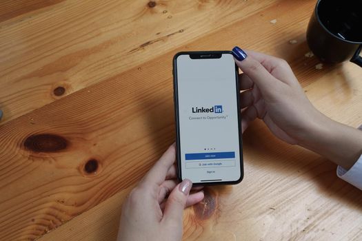 CHIANG MAI, THAILAND : AUG 26, 2022: LinkedIn logo on phone screen. LinkedIn is a social network for search.