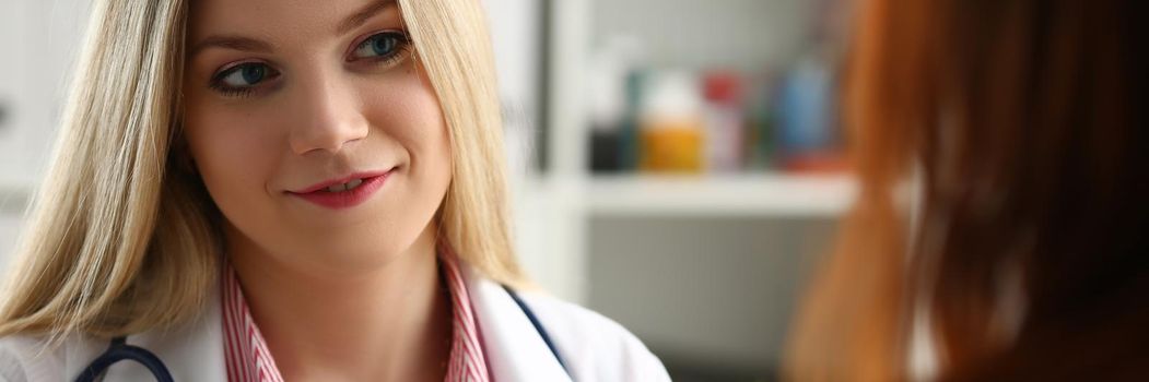 Female doctor explains diagnosis to patient. Medical consultation concept