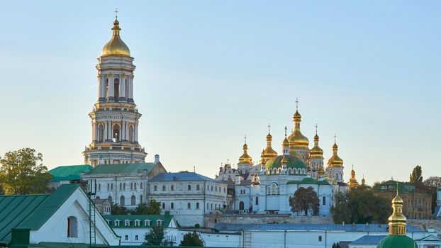 a building used for public Christian worship. Orthodox church with golden domes and blue sky. Monastery Kyiv Lavra