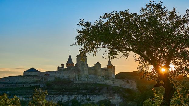 a military stronghold, especially a strongly fortified town fit for a large garrison. The old medieval fortress in all its glory in the rays of the warm setting sun
