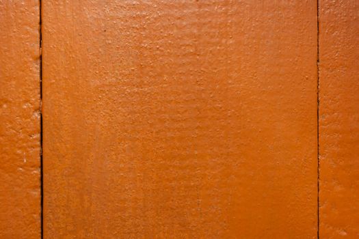 Wooden boards painted in reddish-brown paint. Backdrop