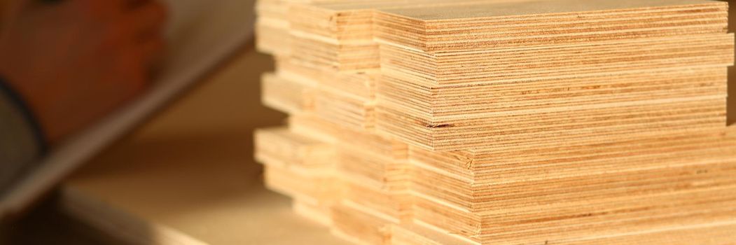 Plank board closeup. Wood plank panel for construction and production furniture. Wood chipboard cutting board warehouse