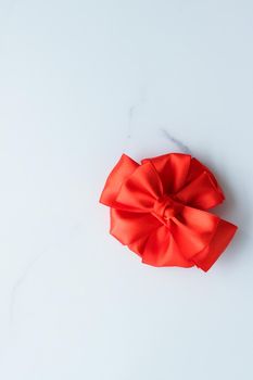 Holiday decor, feminine design and flatlay concept - Red silk ribbon on marble, top view