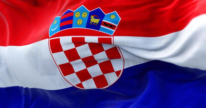 Close-up view of the Croatian national flag waving in the wind. Croatia is a country at the crossroads of Central and Southeast Europe. Fabric textured background. Selective focus