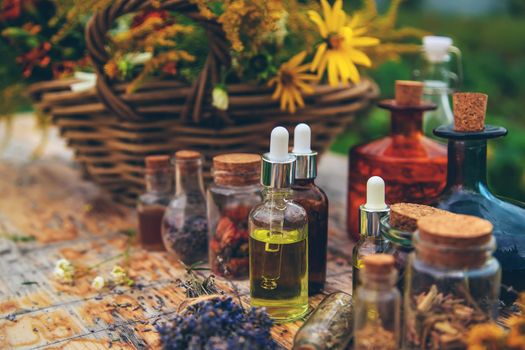 Medicinal herbs and tinctures on the table. Selective focus. Nature.