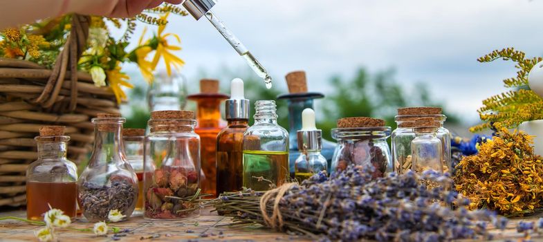 Medicinal herbs and tinctures on the table. Selective focus. Nature.