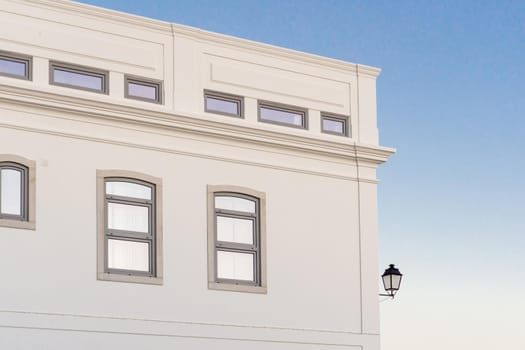 White building at sunset against a blue sky with a vintage lantern background