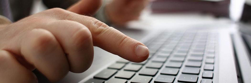 Male hands are holding credit card and typing on keyboard. Financial security and online payments concept