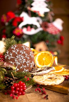 Christmas - baking cake background. Dough ingredients and decorations on vintage planked wood table from above. Rural kitchen layout with free text space.