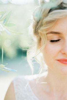 Half face of bride with closed eyes and high hairdo. High quality photo