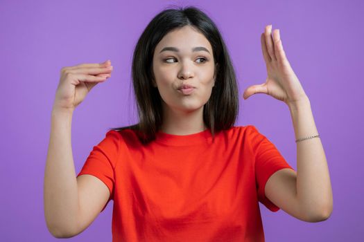Pretty mixed race woman showing bla-bla-bla gesture with hands isolated on purple background. Empty promises, blah concept. Lier. High quality photo