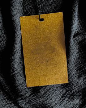 Blank fashion label tag, sale price card on luxury fabric background, shopping and retail concept