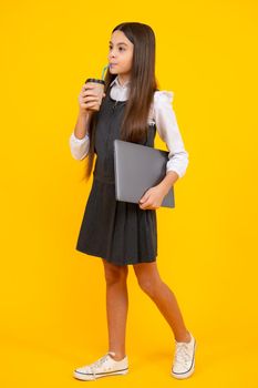 Teenage girl with take away cup of cappuccino coffee or tea. Child with takeaway cup on yellow background, morning drink beverage